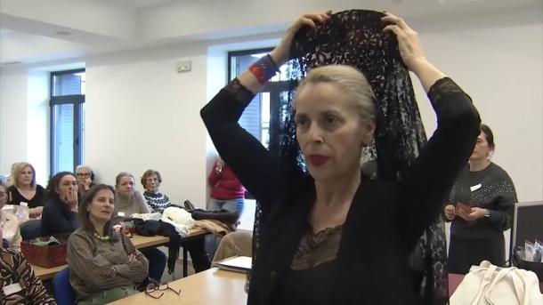 Una de las mujeres que participan en el taller se coloca una mantilla