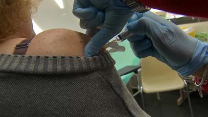 Una mujer recibe la vacuna de la gripe - Imagen de archivo