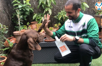 Un usuario con su perro y el bidón de la campaña
