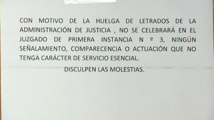 Cartel que anuncia la suspensión de un juicio por la huelga